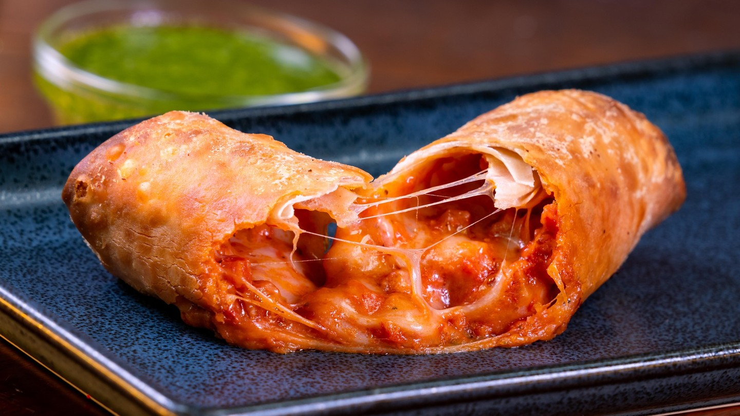 Pepperoni Pizza Egg Roll with pesto dipping sauce